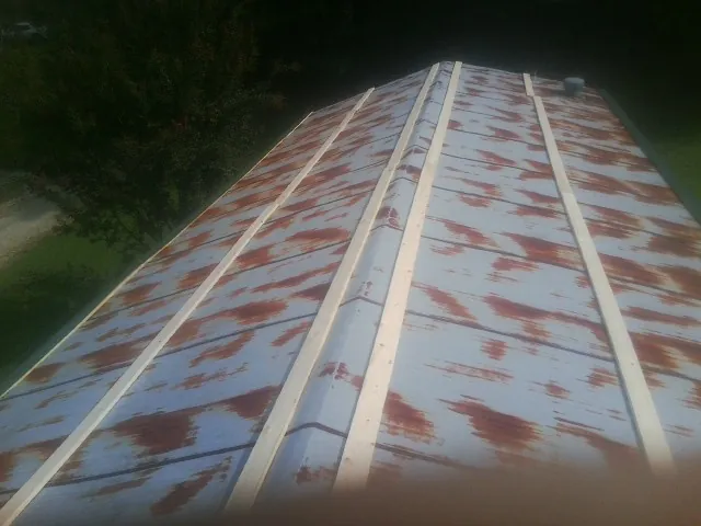 Rusted metal roof panels with new wood purlins before replacement — Storm Damage Roof Repair in Homosassa by Roofing Brothers