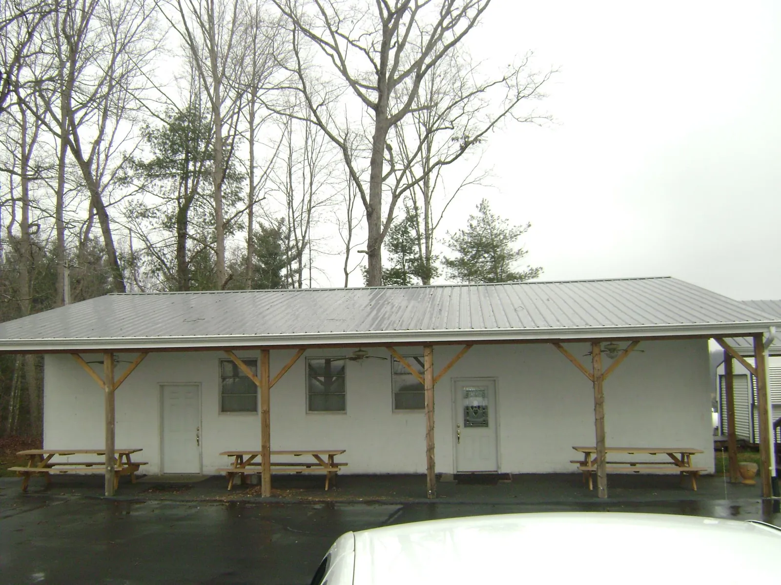 Gray metal roof over a block building with a timber post porch in Homosassa